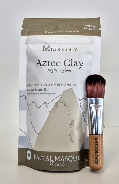 Mudology Aztec Clay facial masque package with a brush on a white background