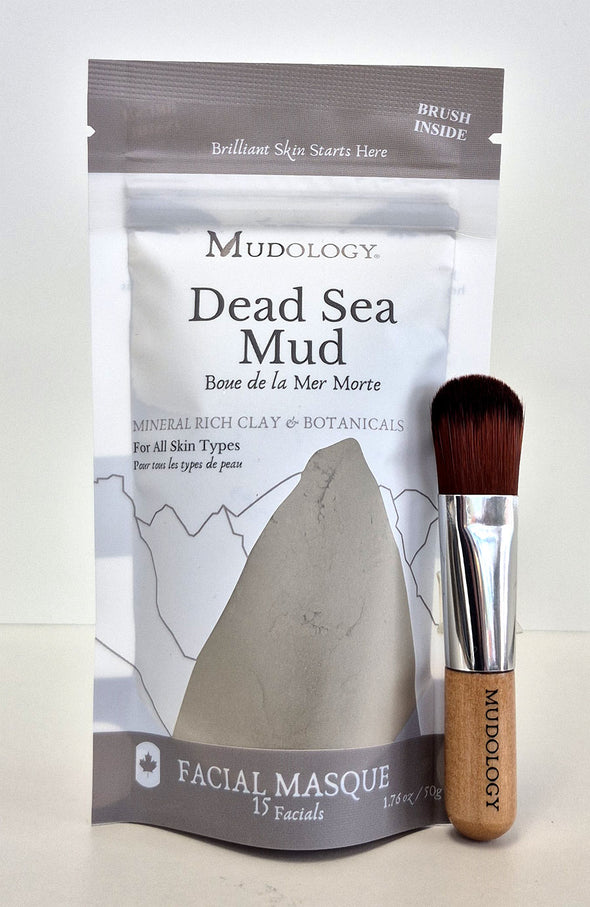 Mudology Dead Sea Mud facial masque packaging with a brush on a white background