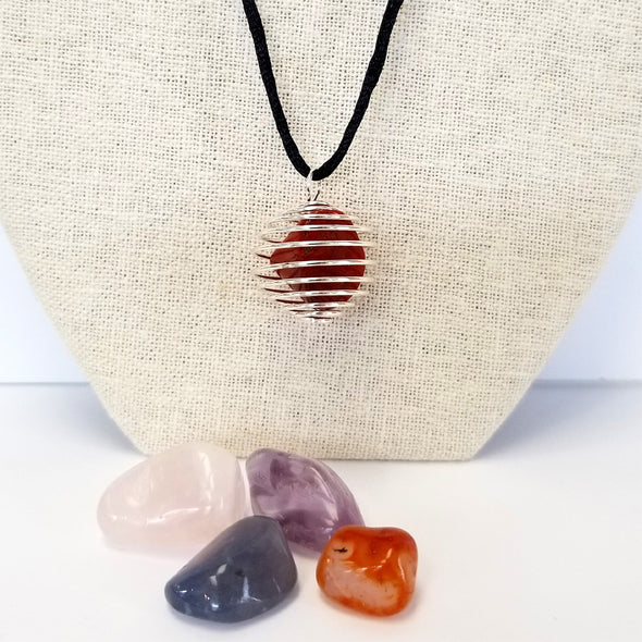 A Red Jasper polished stone mounted in the coil cage necklace.